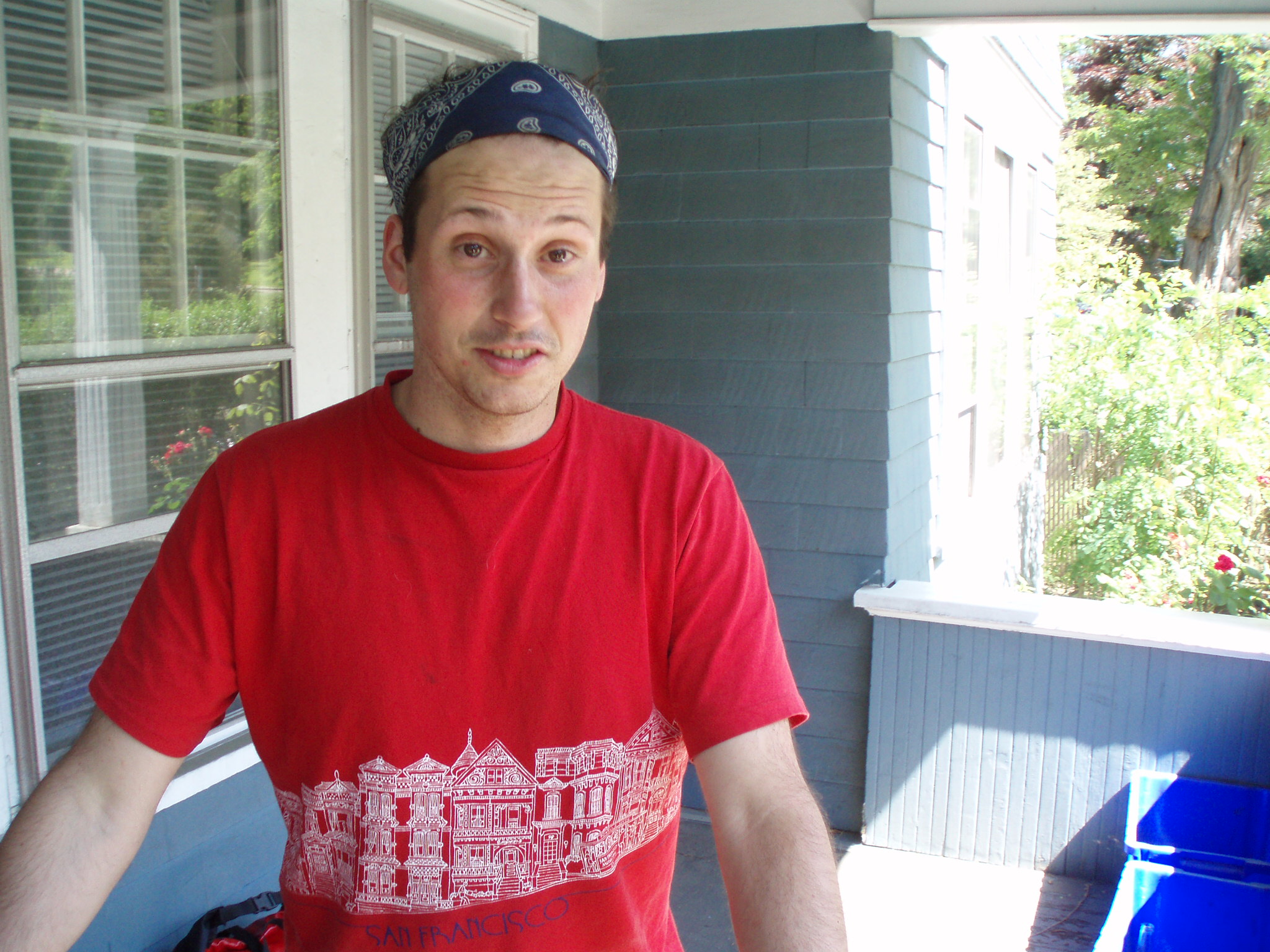 Mike Riscica wearing a red shirt and a bandanna